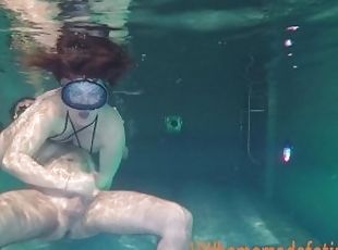 Couple having fun underwater.