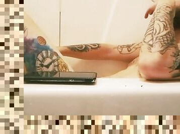 Tattooed bearded daddy bear in the tub for a soak, toke, and stroke.