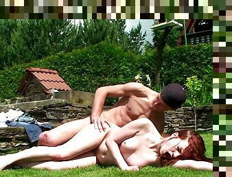 Teen redhead is getting fucked on the grass