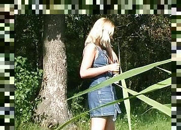 Naked blonde girl pisses outdoors