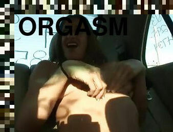 Sexy blonde has an intense orgasm in the backseat of a car
