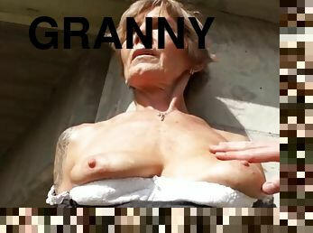 Granny with a perfect body sucking cock outdoors