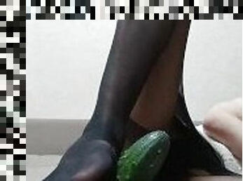 cute femboy in stockings has fun footjobing a cucumber