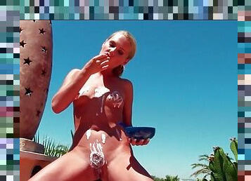 Blonde girl spreads yogurt on her naked body