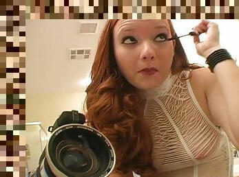 Hot redhead puts on her makeup