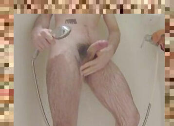 A man masturbates in the shower