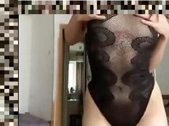 young tattooed girl in a transparent swimsuit teases you after work