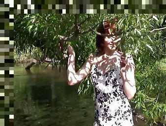 Adorable redhead teen takes a naked dip in a river