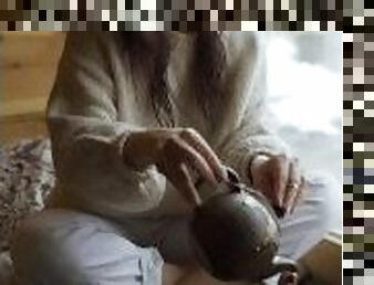 A girl filling tea into a classic cup