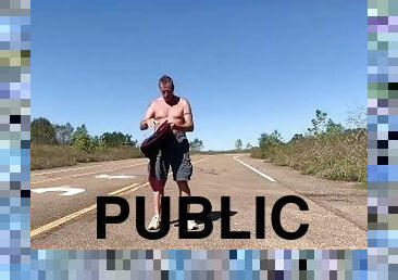 Stripping naked on a public road and jacking off before getting dressed again.