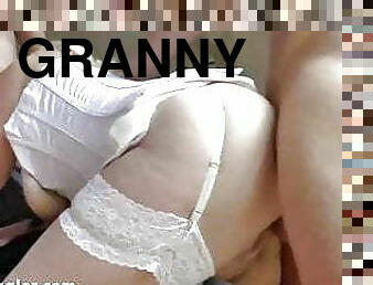 White haired English granny with big tits takes two cocks