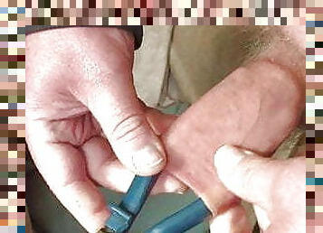 Foreskin with large blue pliers 