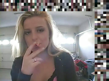 Blondie cutie puffing smoke seductively