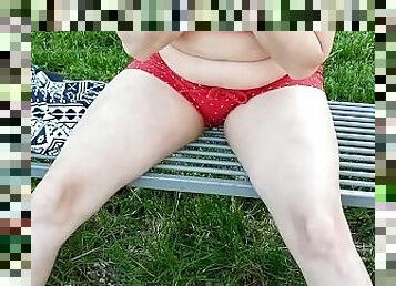 Discreet peeing in the park through my red shorts