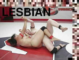 Lesbian bdsm battlers wrestling in ring before strapon sex