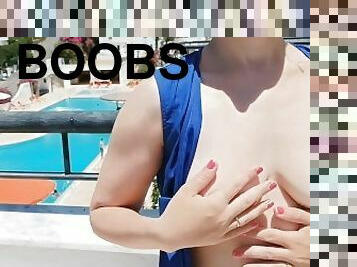 Flashing sexy boobs on the balcony, hottie unbuttoned her dress in public - no bra