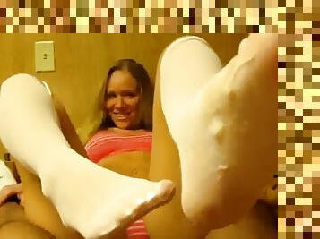 Hottie in white nylon gives footjob to a big dick