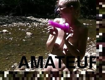 Masturbating with Wolf dildo in creek