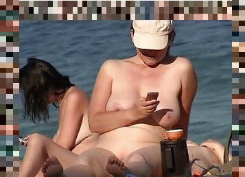 Shameless nudist babes sunbathing on the beach on spy cam