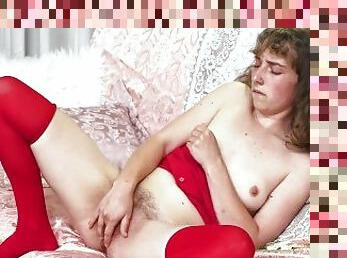 Slender amateur cutie in red stockings fingers her hairy pussy on Christmas Day