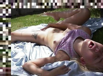 Small titted blonde babe masturbates in the backyard