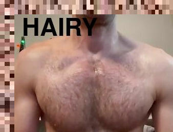 Hot and hairy man grease himself up with lotion