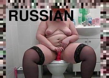 Fat Russian woman in stockings enjoys riding red dildo