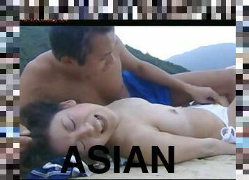 Young Asian couple fucking by the water on the beach
