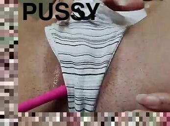 Naked woman uses a vibrator on her pussy
