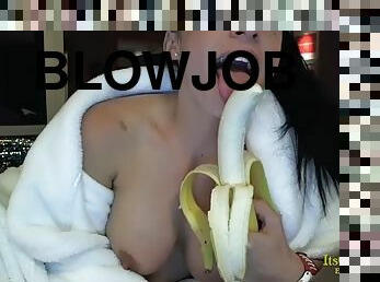 Smiling girl wearing a bathrobe eats banana