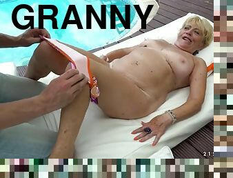 Granny fucks beside a pool