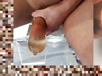 beautiful hard cock is pissing in condom and fucks his pee into big cumshot with floating sperm and great 2 cam POV