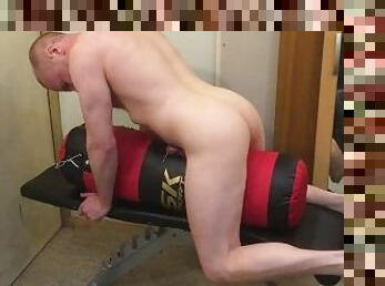 Muscular Daddy grunts as he fucks his boxing punch bag and cums all over it.