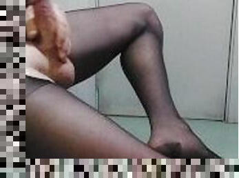 Guy in black pantyhose plays with his cock until he creams himself all over his nylon legs
