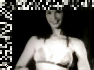 A sexy brunette dances striptease 1950 vintage