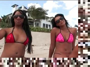 Two ebony babes in bikinis on the beach