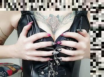 Love my breasts! A dominatrix in a leather corset teases you with her tits