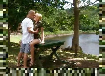 Hot blonde by the lake sitting on a large dick