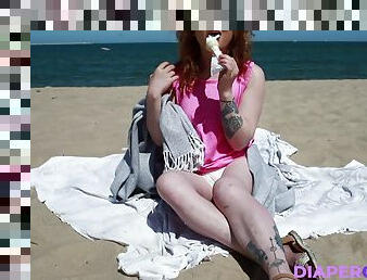 Diapered girl is eating an ice cream