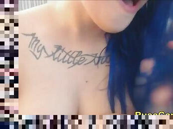 Closeup squirt blue hair punk teen with tattoos
