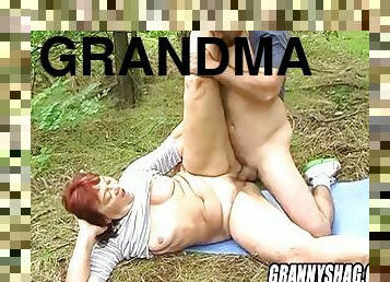 Grandma fucks uninhibitedly with a huge cock in the forest
