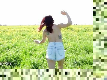 Tattooed up teen with perky boobs in the field shows her precious cans