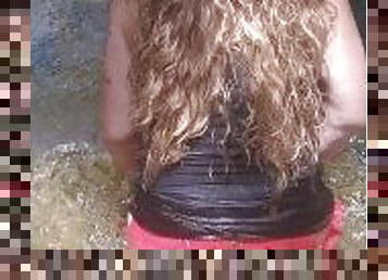 Country Girl Crawling On Her Hands and Knees In Water At Popular Spring Creek Collecting Rocks