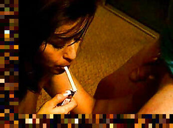 Brunette gives blowjob while smoking