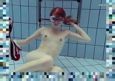 Teen redhead in the deep end of the pool