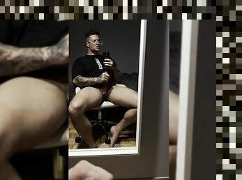 Gay bodybuilder sitting and stroking his massive GAY dick slowly