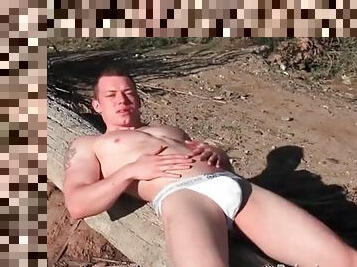 Solo muscular guy in jockstrap on the beach