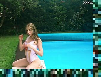 Petite Russian Marfa swims naked in the pool