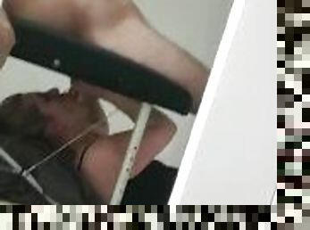 Blonde slut sucking cock from under massage table
