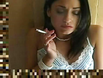 Brunette poses whiel smoking